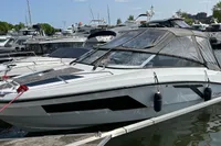 2022 Finnmaster T7 boat docked in a marina, featuring sleek design and protective canopy.