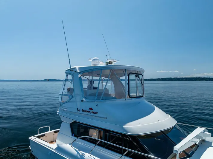 Bumber Shoot Yacht Photos Pics 2006 Silverton 42 Convertible yacht on calm blue water under clear sky.