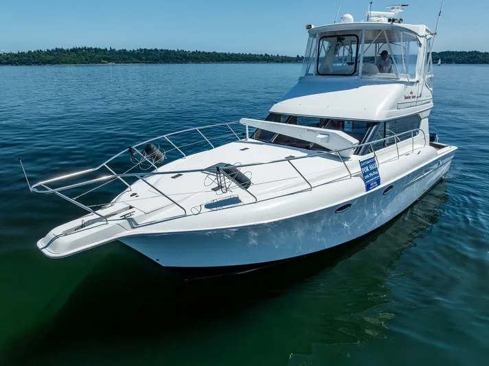 Bumber Shoot Yacht Photos Pics 2006 Silverton 42 Convertible yacht on calm water, showcasing sleek design and spacious deck.