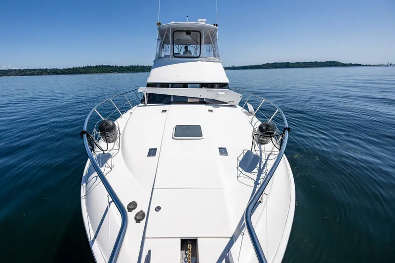 Bumber Shoot Yacht Photos Pics 2006 Silverton 42 Convertible yacht on calm water, showcasing sleek design and spacious deck.