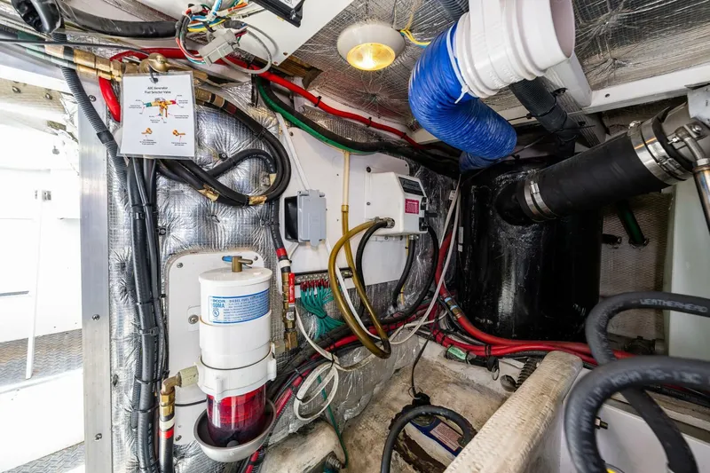 Bumber Shoot Yacht Photos Pics Engine room of 2006 Silverton 42 Convertible with wiring and mechanical components.