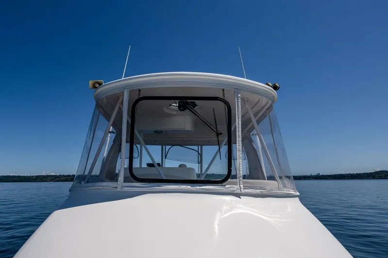 Bumber Shoot Yacht Photos Pics 2006 Silverton 42 Convertible boat on calm water under clear blue sky.