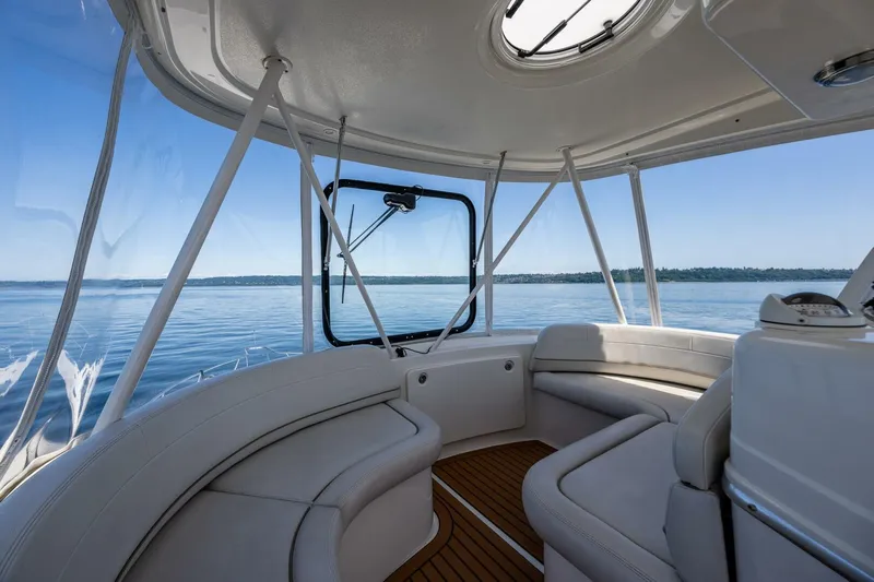 Bumber Shoot Yacht Photos Pics Interior view of 2006 Silverton 42 Convertible yacht with panoramic windows and plush seating.