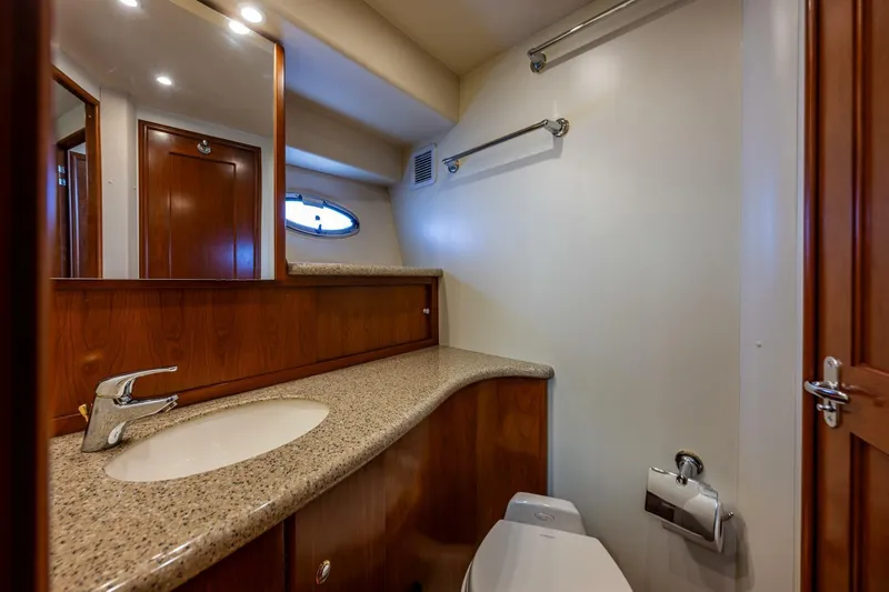 Bumber Shoot Yacht Photos Pics Luxurious bathroom in 2006 Silverton 42 Convertible yacht with granite countertop and wooden cabinetry.