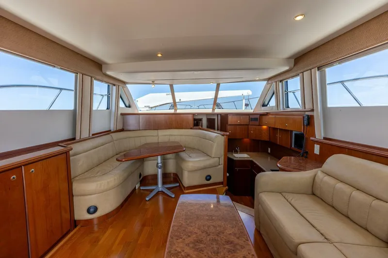 Bumber Shoot Yacht Photos Pics Luxurious interior of a 2006 Silverton 42 Convertible yacht with elegant seating and wood finishes.