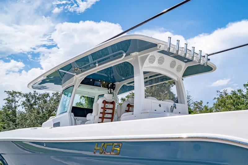  Yacht Photos Pics 2021 HCB Lujo boat with sleek design, blue and white color scheme, under a clear sky.