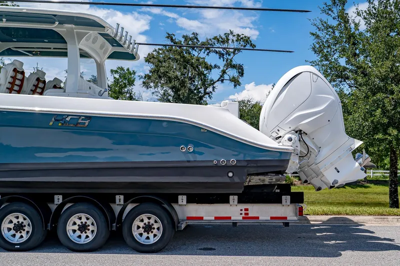  Yacht Photos Pics 2021 HCB Lujo boat on trailer, featuring sleek design and powerful outboard engines.