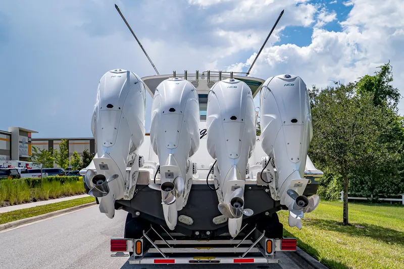  Yacht Photos Pics Four powerful outboard engines on a 2021 HCB Lujo boat, parked on a sunny street.