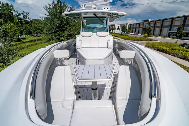  Yacht Photos Pics Luxury 2021 HCB Lujo boat with sleek white seating and table, docked outdoors.