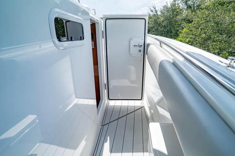  Yacht Photos Pics 2021 HCB Lujo yacht interior with open door, sleek white design, and outdoor view.