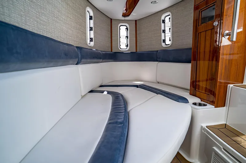  Yacht Photos Pics Luxurious interior of 2021 HCB Lujo boat with plush seating and elegant wood finishes.