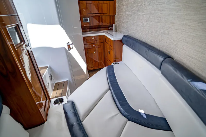 Yacht Photos Pics Luxurious interior of 2021 HCB Lujo boat with seating and wooden cabinetry.