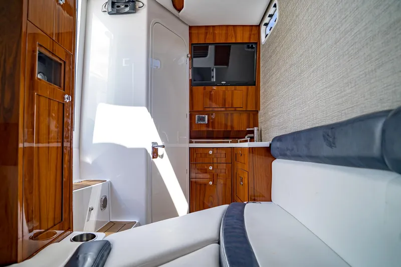  Yacht Photos Pics Luxurious interior of 2021 HCB Lujo boat with wood cabinetry and modern amenities.