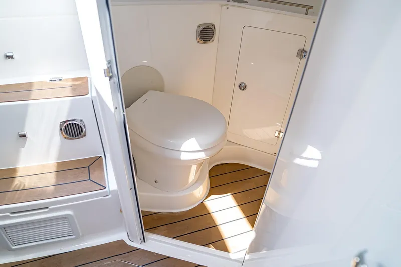  Yacht Photos Pics 2021 HCB Lujo boat bathroom with wooden flooring and modern fixtures.