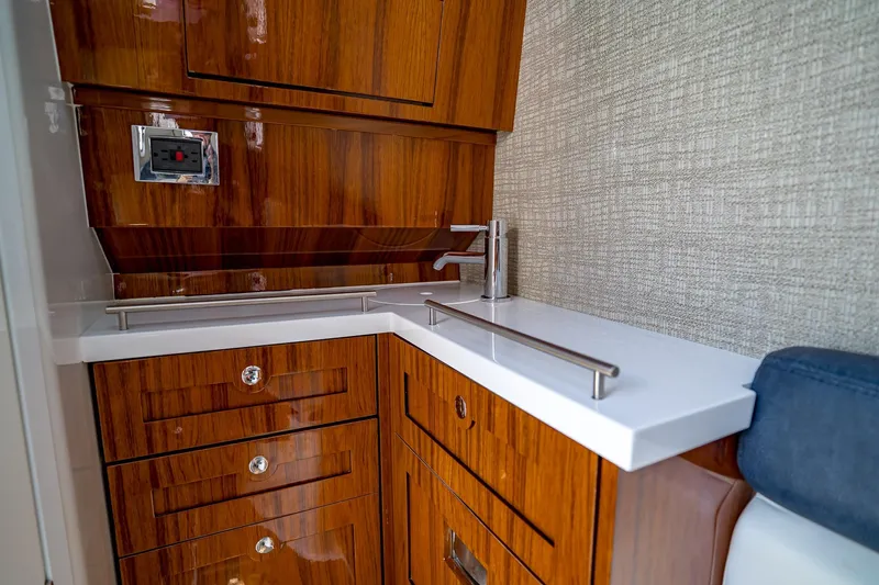  Yacht Photos Pics Luxurious wooden cabinetry and sleek countertop in 2021 HCB Lujo boat interior.