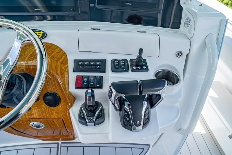  Yacht Photos Pics Control panel of 2021 HCB Lujo boat with steering wheel and navigation controls.