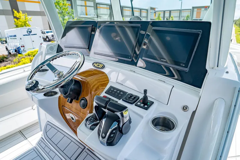  Yacht Photos Pics 2021 HCB Lujo boat dashboard with steering wheel and multiple navigation screens.