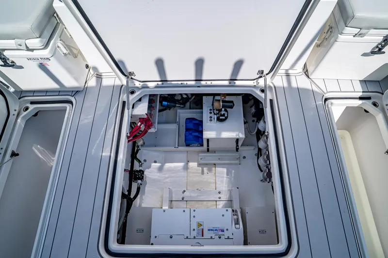  Yacht Photos Pics Open hatch of 2021 HCB Lujo boat showing interior equipment and storage compartments.