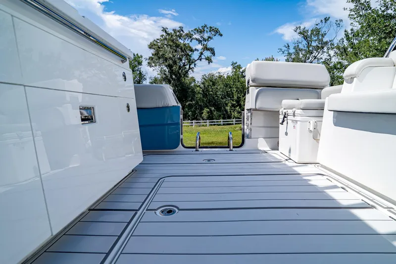  Yacht Photos Pics 2021 HCB Lujo boat deck with seating, white cabinetry, and scenic outdoor view.