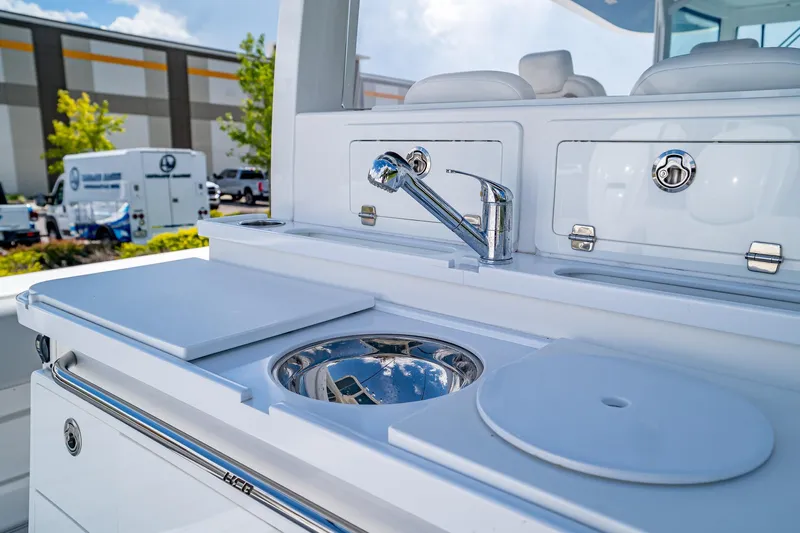 Yacht Photos Pics Luxury yacht kitchen area on 2021 HCB Lujo, featuring sleek sink and cutting board.