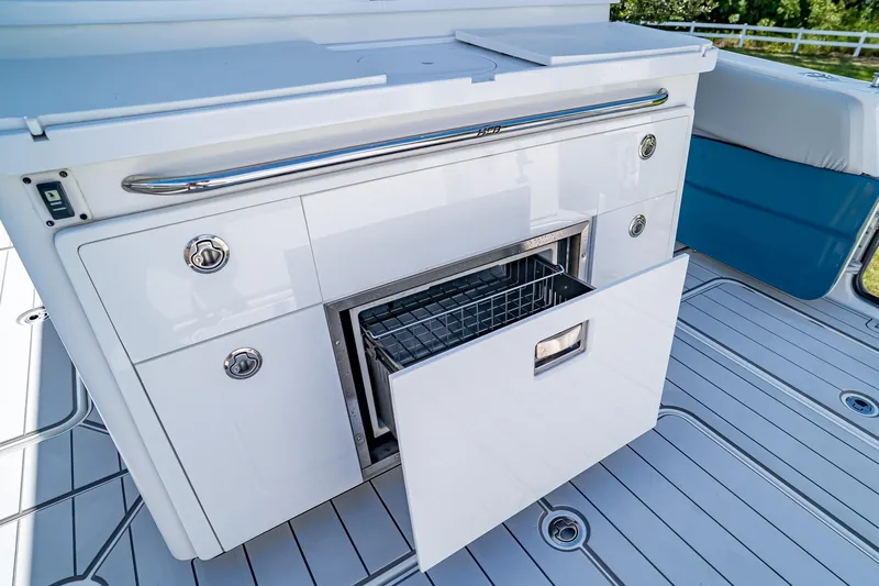  Yacht Photos Pics Luxury HCB Lujo 2021 boat interior with open storage drawer on sleek deck.