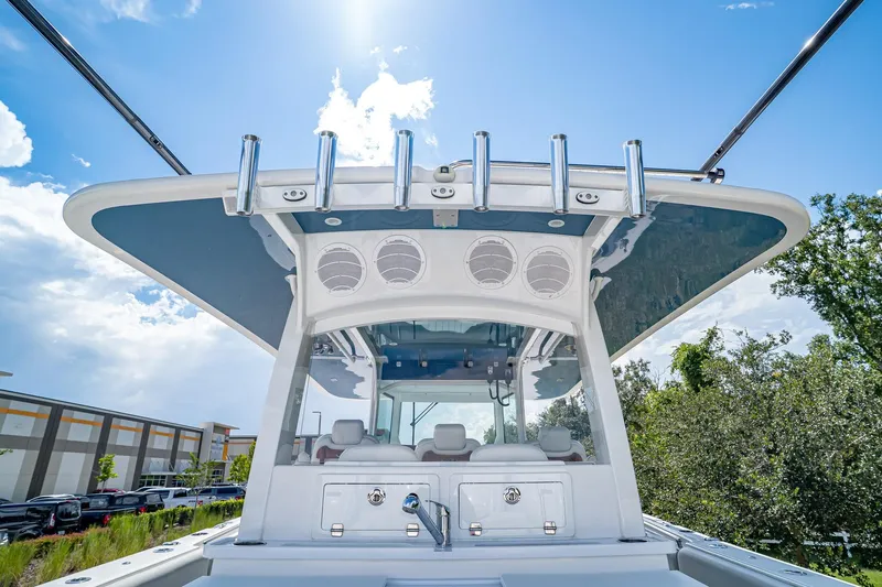  Yacht Photos Pics 2021 HCB Lujo boat helm with rod holders and speakers under a sunny sky.