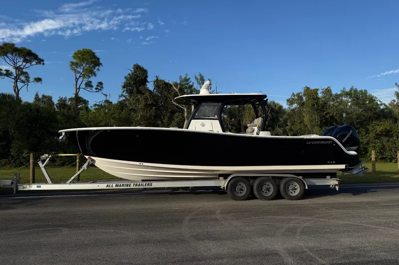 Reel Ruthless Yacht Photos Pics 2022 Sportsman Open 322 Center Console boat on trailer, parked outdoors.