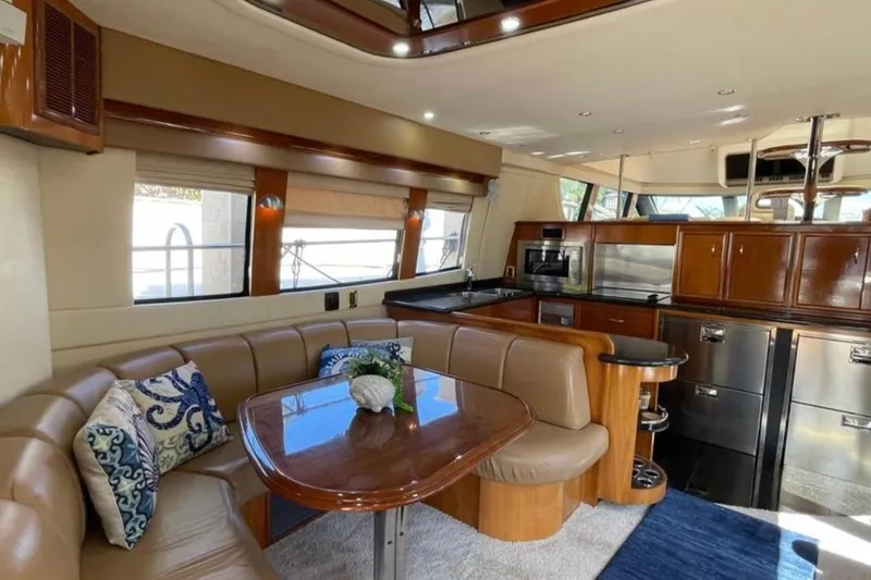  Yacht Photos Pics Luxurious interior of 2005 Carver 56 Voyager yacht with elegant dining area and modern kitchen.