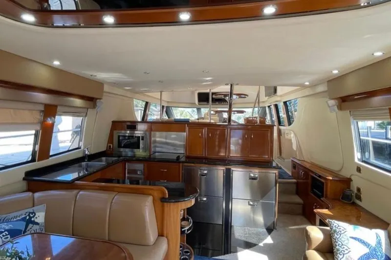  Yacht Photos Pics Luxurious interior of 2005 Carver 56 Voyager yacht with modern kitchen and seating area.