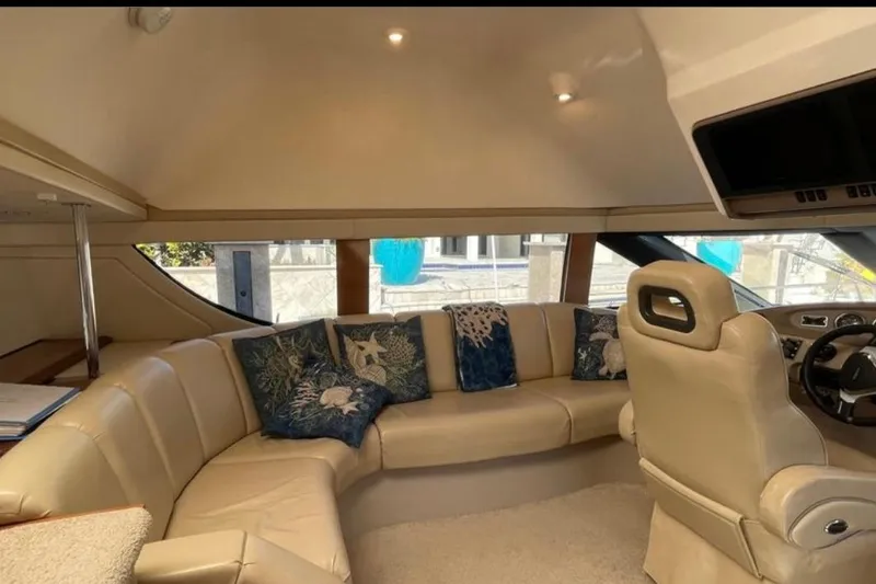  Yacht Photos Pics Luxurious interior of 2005 Carver 56 Voyager yacht with plush seating and decorative pillows.