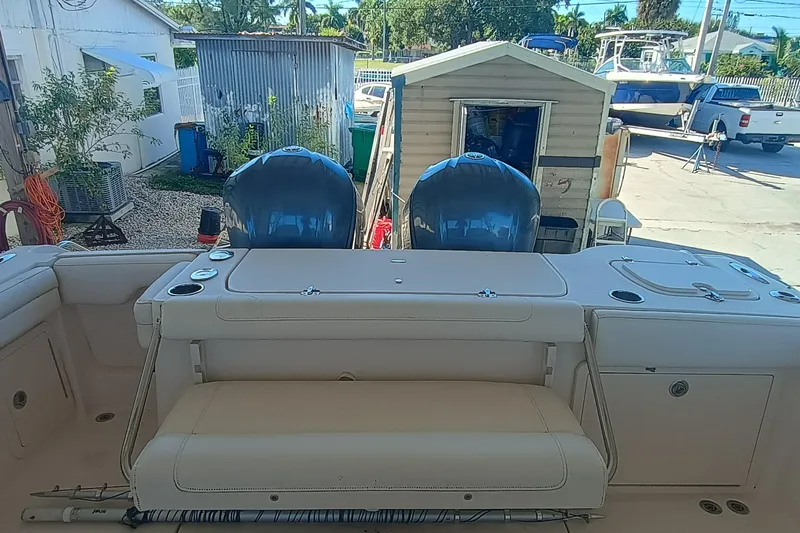 325-719 Brokerage Josh Yacht Photos Pics 2021 Grady-White Freedom 325 boat with dual engines and beige seating in a yard.