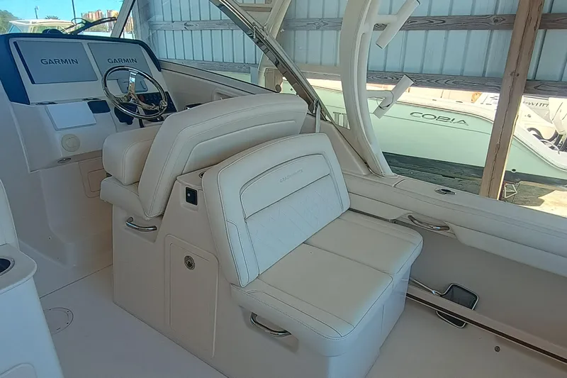 325-719 Brokerage Josh Yacht Photos Pics 2021 Grady-White Freedom 325 boat interior with Garmin displays and luxurious seating.
