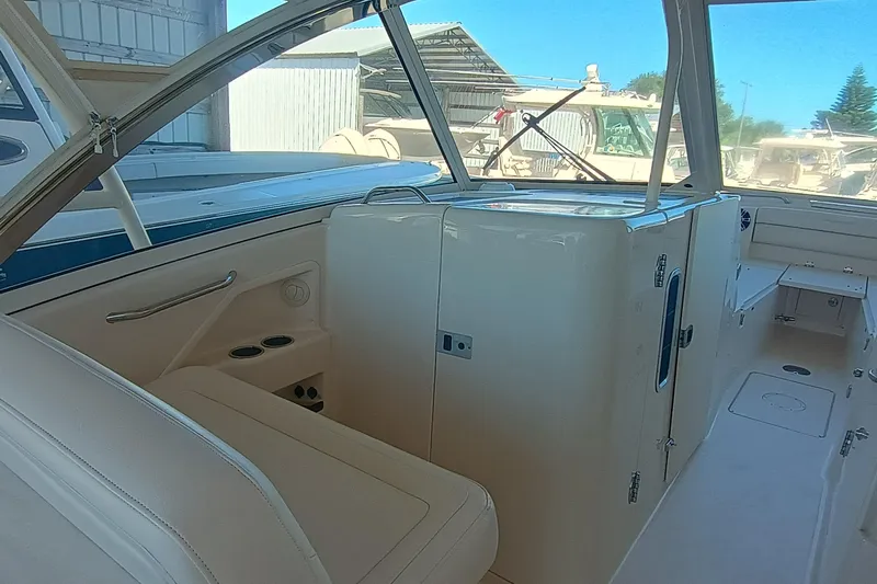 325-719 Brokerage Josh Yacht Photos Pics 2021 Grady-White Freedom 325 boat interior with seating and storage compartments.