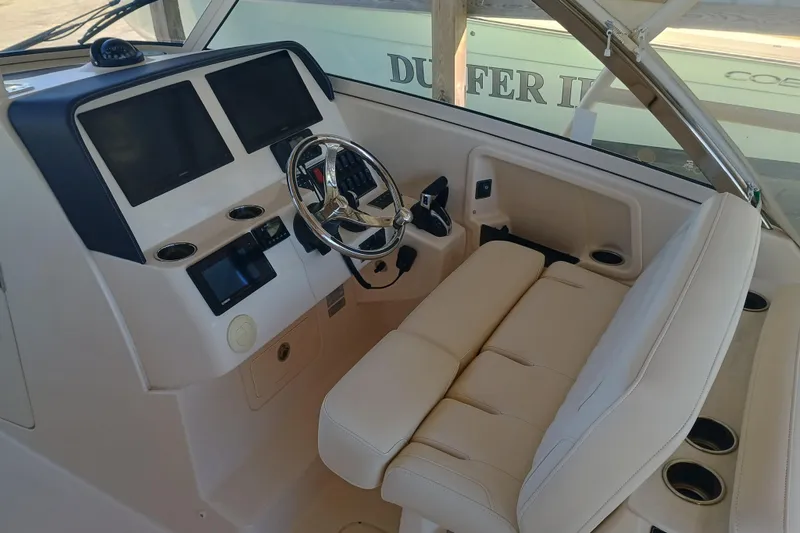 325-719 Brokerage Josh Yacht Photos Pics 2021 Grady-White Freedom 325 boat cockpit with dual screens and leather seating.