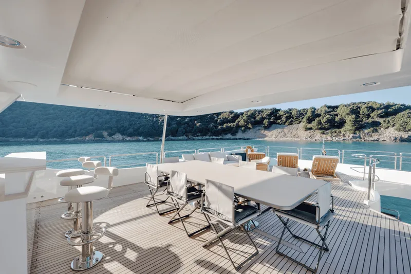Serendipity Yacht Photos Pics Luxurious 2008 Azimut 116 yacht deck with seating, overlooking serene blue waters.