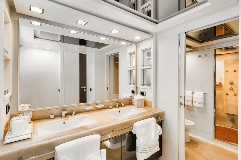 Serendipity Yacht Photos Pics Luxurious bathroom interior on 2008 Azimut 116 yacht, featuring dual sinks and modern fixtures.