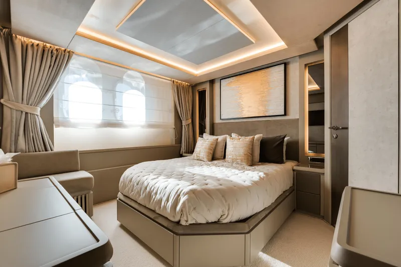 Serendipity Yacht Photos Pics Luxurious bedroom interior of 2008 Azimut 116 yacht with elegant decor and soft lighting.