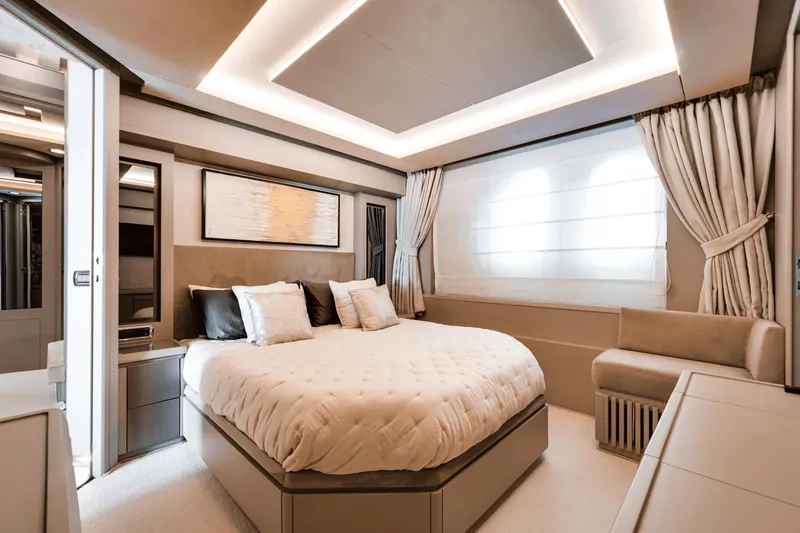 Serendipity Yacht Photos Pics Luxurious bedroom interior on 2008 Azimut 116 yacht, featuring elegant decor and ambient lighting.