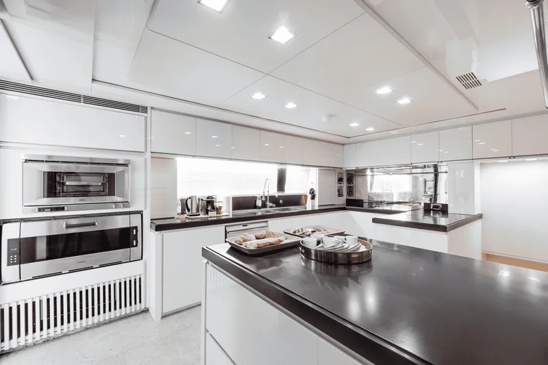 Serendipity Yacht Photos Pics Luxurious kitchen interior on 2008 Azimut 116 yacht, featuring modern appliances and sleek design.