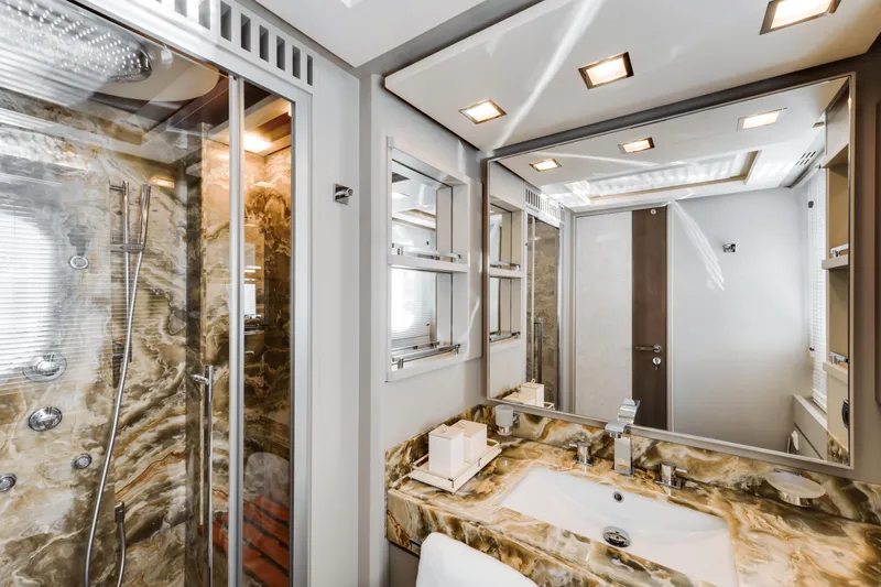 Serendipity Yacht Photos Pics Luxurious bathroom in 2008 Azimut 116 yacht with marble accents and modern fixtures.