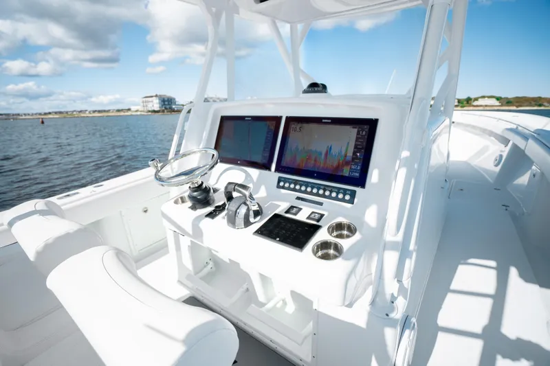 Afishinsea Yacht Photos Pics 2014 Yellowfin 39 Offshore boat dashboard with dual screens and steering wheel.