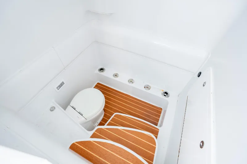 Afishinsea Yacht Photos Pics 2014 Yellowfin 39 Offshore boat interior with wooden flooring and compact toilet.
