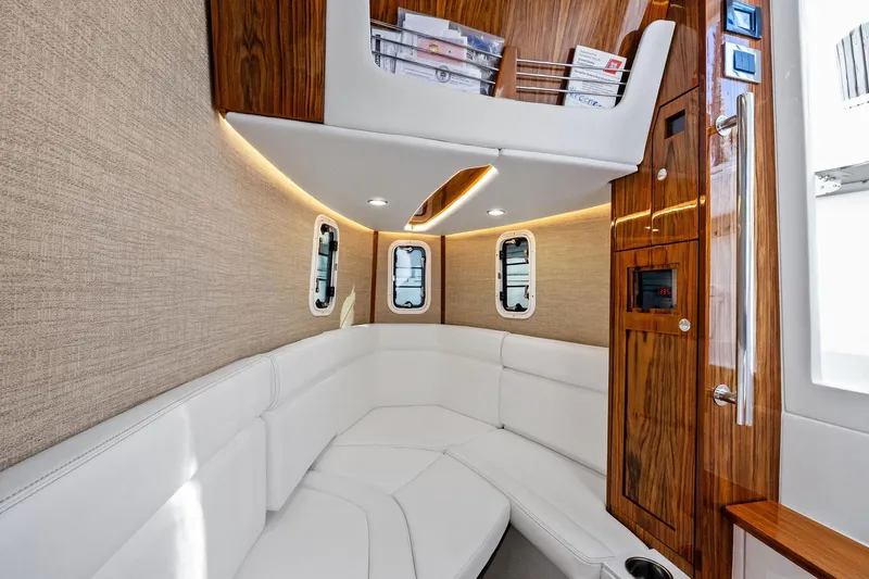 No Name Yacht Photos Pics Luxurious interior of 2023 HCB 42 Lujo boat with white seating and wood accents.