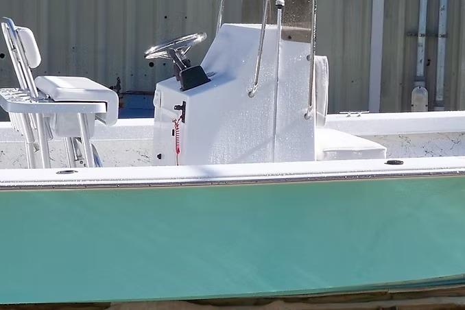2026 C-Hawk 23 Center Console boat with teal hull and white interior.