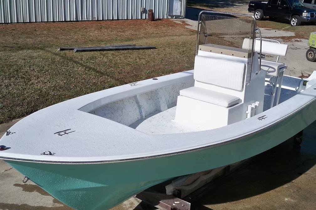 2026 C-Hawk 23 Center Console boat with white seating and teal hull.