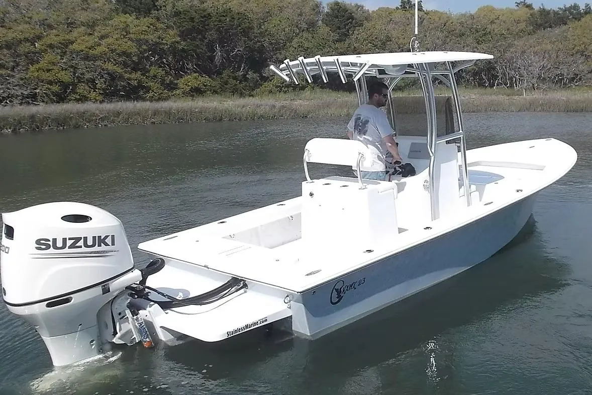 2026 C-Hawk 23 Center Console boat with Suzuki engine on calm water.