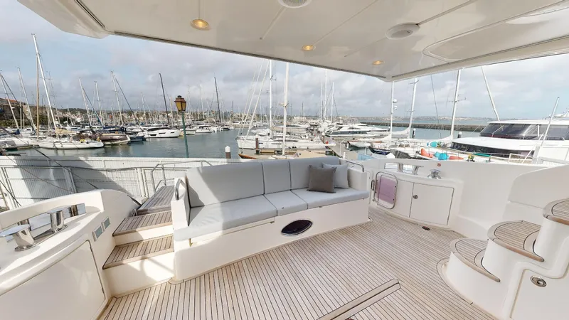  Yacht Photos Pics Luxurious 2011 Azimut 58 yacht deck with seating, overlooking marina with sailboats.