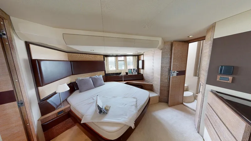  Yacht Photos Pics Luxurious bedroom interior of a 2011 Azimut 58 yacht, featuring a cozy bed and modern decor.