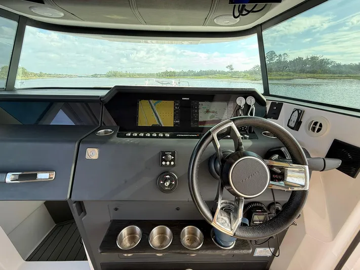  Yacht Photos Pics Helm of 2023 Axopar 37 Cross Cabin with navigation display and steering wheel.