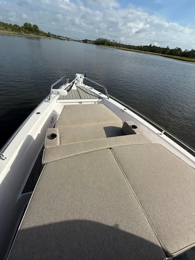  Yacht Photos Pics 2023 Axopar 37 Cross Cabin boat with spacious deck and scenic water view.